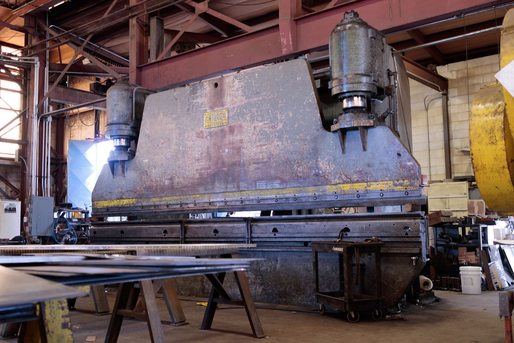 Heavy steel press inside a trailer fabrication shop